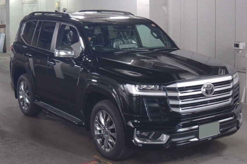 Black Toyota Land Cruiser 4WD ZX in a showroom setting