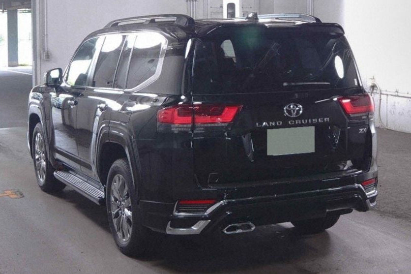 Black Toyota Land Cruiser 4WD ZX in a showroom setting