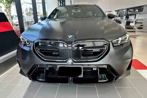 Front view of a black BMW car in a showroom