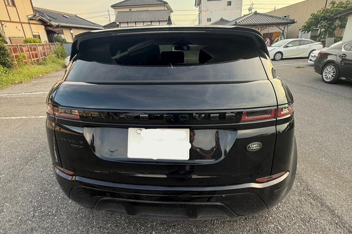 Black SUV with a license plate in an urban setting