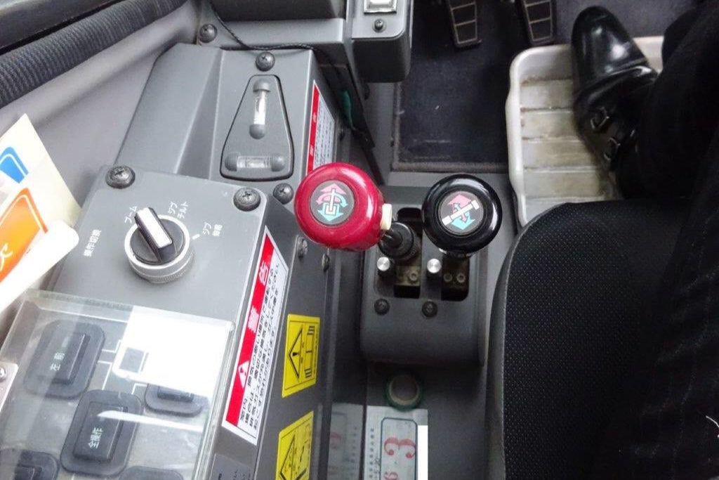 Close-up of a car's dashboard with battery and controls