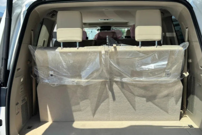 Car interior with a folded car seat cover on the back seat